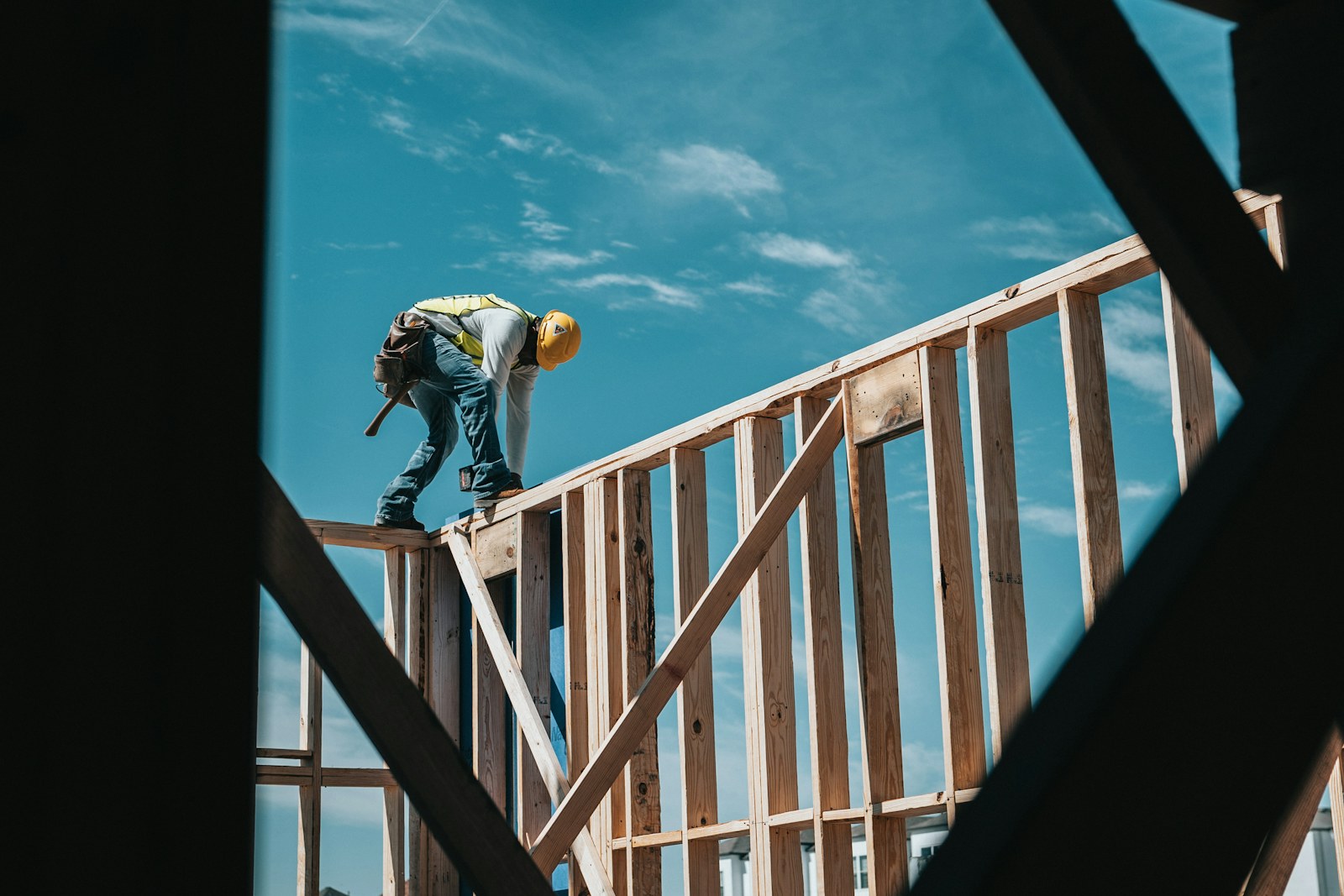 A construction worker building a timber frame