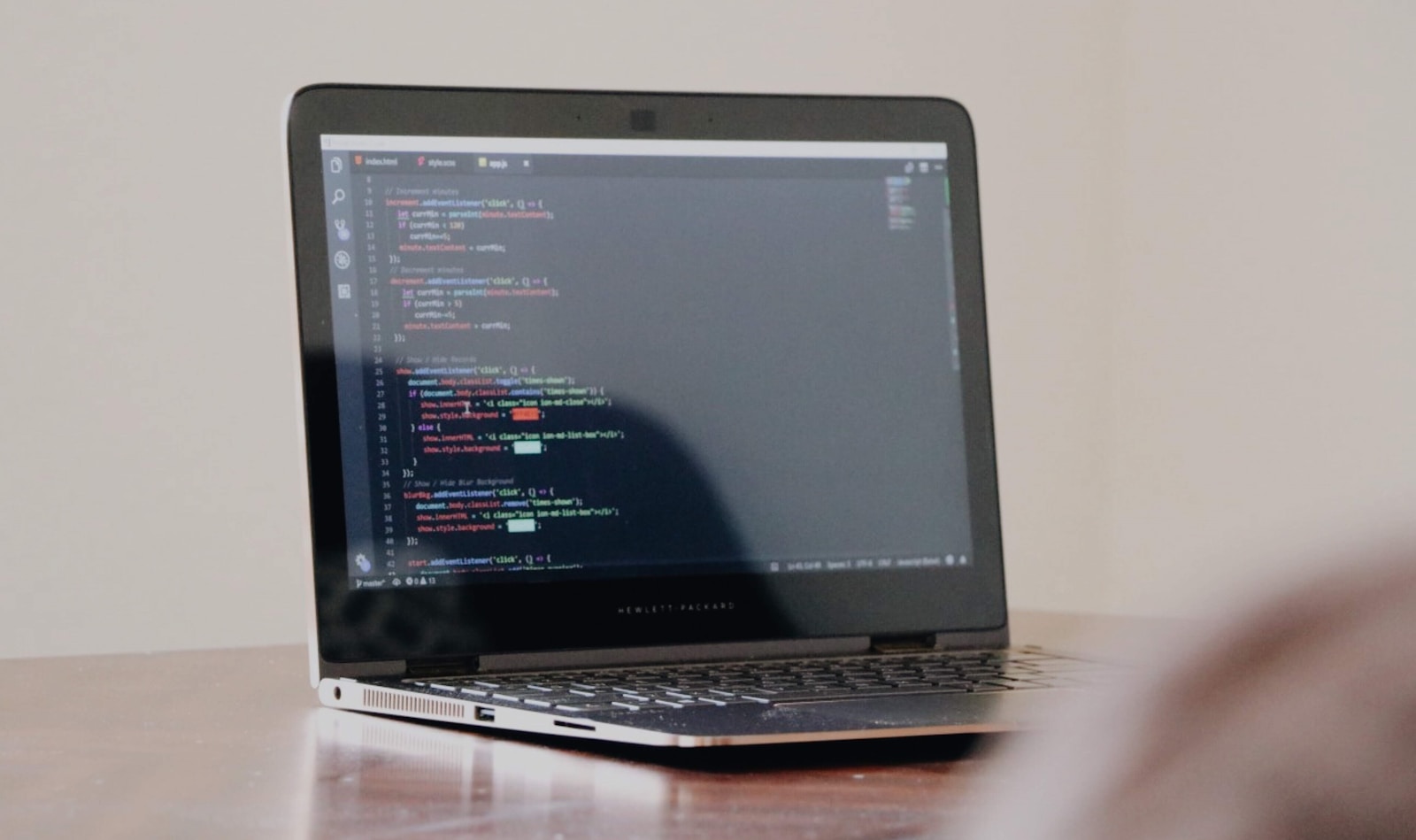 A laptop displaying programming code